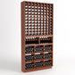Dark wood wine cellar rack with bottle slots in columns and cubby storage bins