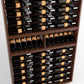 Wine bottle display rack with multiple rows of stored bottles on wooden shelves