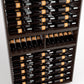 Wine bottle storage rack with stacked bottles on wooden tiers and open front shelves