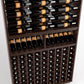 Close-up of wine bottles in wooden rack: horizontal rails above, vertical slots below