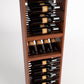 Wood wine bottle display rack with bottle slots and a glassware compartment