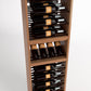Angled view of light wood wine rack showing bottle rows on rail supports