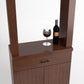 Wine tasting cabinet with mirror shelf and stemmed glass beside wine bottle