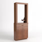 Light wood cabinet tasting station with open frame and lower storage doors; wine glass shown.