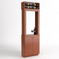 Light wood tasting station with top wine bottle rack, open frame, drawer, and storage doors.