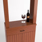 Red-brown wood cabinet tasting station with two doors, drawer, and top wine bottle & glass