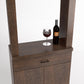 Walnut brown cabinet tasting station with two doors, drawer, and top wine bottle & glass