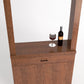 Medium brown wood wine tasting cabinet with wine glass and bottle on ledge
