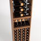 Wood wine display rack with upper bottle holder rails and lower wine bottle cubbies
