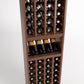 4-column wine cellar rack close-up with bottle cubbies and wine glass shelf, warm wood.