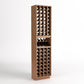 Tall light wood wine cellar rack with four-column bottle slots and a small bottle tray shelf