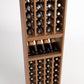 Front view of a light wood wine rack with bottle cubbies, a front wine tray, and lower rows