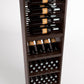 Wood wine rack interior with bottle rails, wine bottles in rows, and cork bottle bins
