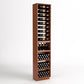 Tall light-wood wine rack with bottle rails and stacked wine bottle bins for cork storage