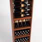 Tall wooden wine rack with four bottle rails and stacked wine bottle storage bins
