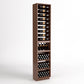 Tall dark-wood wine rack with bottle rails, wine bins, and cork bottle holders
