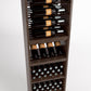 Front view wooden wine rack with four rails holding bottles and lower bin for bottles