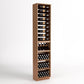 Tall light-wood wine rack with 4-column bottle rails, wine bins, and cork bottle storage