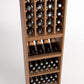 Wooden 4-column wine rack with bottle grid, front-facing bottles, and lower rows