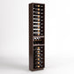 Full-height angled view of wooden wine rack with four rails holding wine bottles