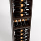 Dark wood wine bottle rack with 4-column rails holding wine bottles