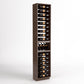 Dark wood wine bottle display rack with stacked bottle rows and glass holder shelf