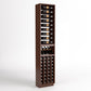 Tall dark wood wine rack with bottle slots, glass rests, and front bottle cubbies