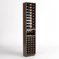 Tall wooden wine rack column with bottle rails, angled bottle slots, and lower cork storage