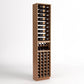 Tall light wood wine rack with bottle slots, glass rests, and front wine bottle cubbies