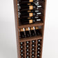 Wood wine rack with bottle rails, row of bottles on the middle shelf, and lower bottle cubbies
