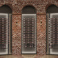 Low-profile wine bottle display with dark metal posts and multiple bottle rows