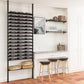 Black wine bottle rack system with multiple rows mounted in a kitchen.