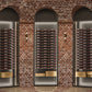 Low-profile wine bottle display with dark metal posts and multiple bottle rows