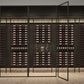 Wall-mounted wine bottle rack with multiple shelves and a central display niche.
