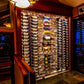 Wall-mounted wine bottle rack with bottles displayed in a clear wall panel