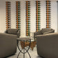 Wall-mounted wine bottle rack with curved hooks holding multiple bottles; metal frame