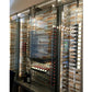 Wine bottle display inside glass door cabinet with metal bottle racks