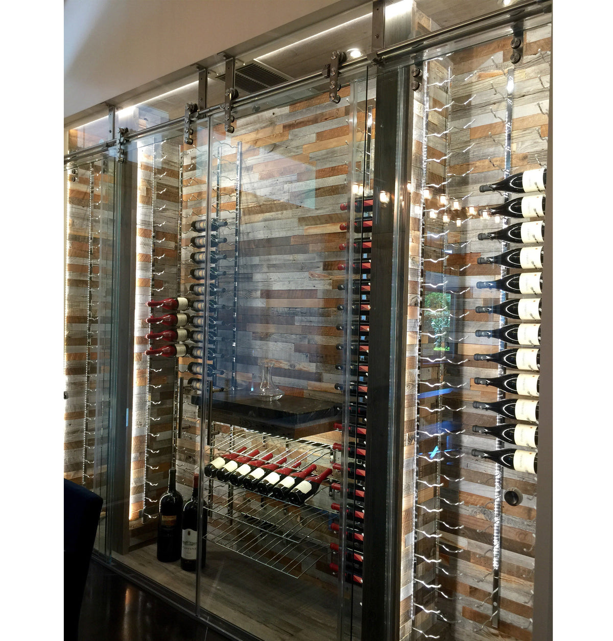 Wine bottle display inside glass door cabinet with metal bottle racks
