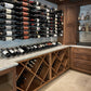 Wine bottle wall display with rows of bottles and a wooden wine storage cabinet