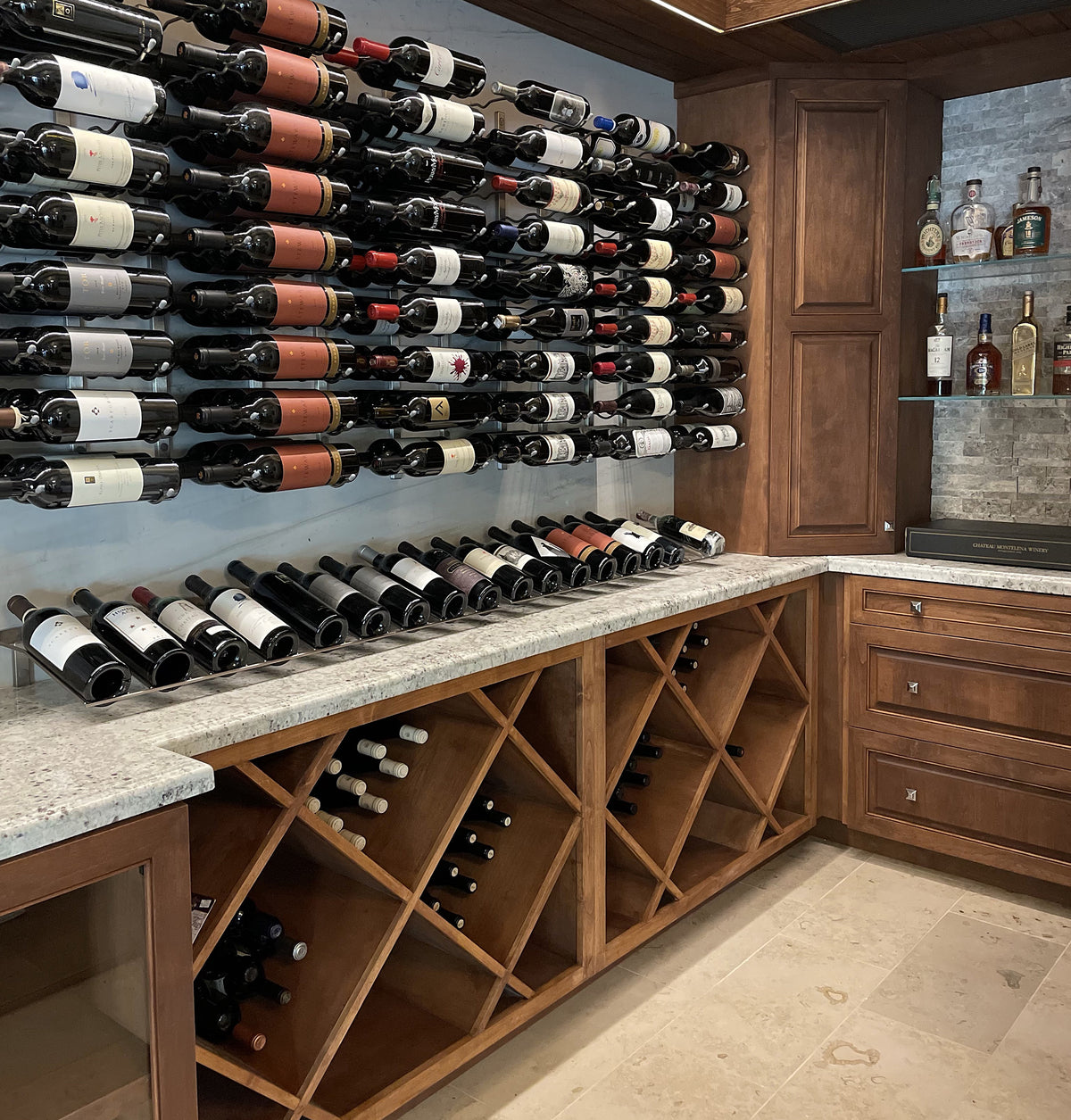 Wine bottle wall display with rows of bottles and a wooden wine storage cabinet