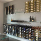 Wall-mounted wine bottle storage system with glass shelves and bottle racks