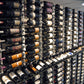 Wall-mounted wine bottle display with multiple black bottles in a grid rack