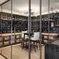 Wine bottle wall storage with dark metal grid shelves holding bottles