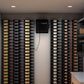 Wine cellar cooling system with bottle storage racks on both sides and controller screen