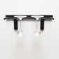 Black wall-mounted stemware rack with two glass cups hanging from hooks