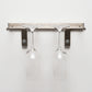 Silver-tone wall-mounted stemware rack with two hanging wine glasses
