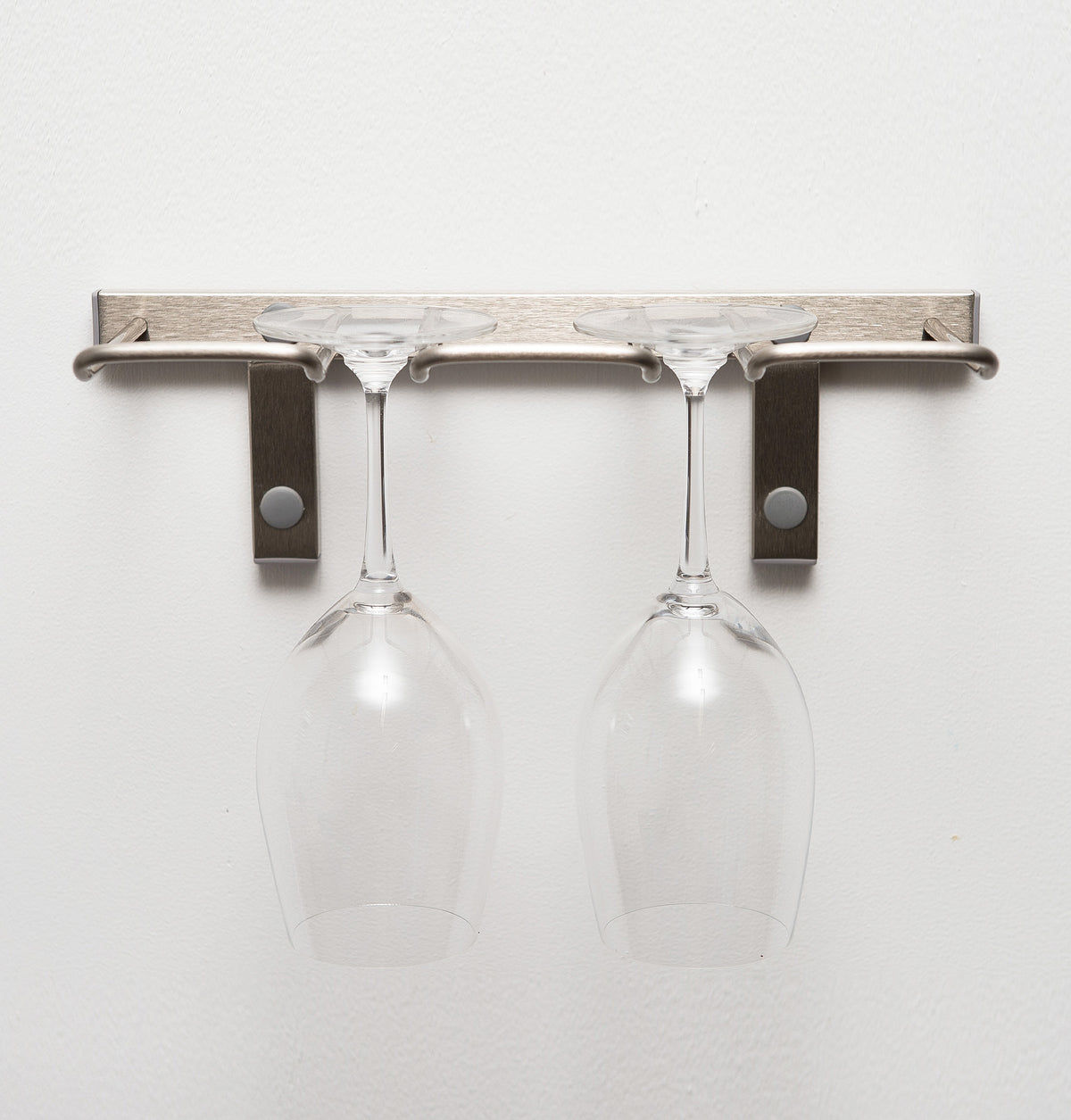 Silver-tone wall-mounted stemware rack with two hanging wine glasses