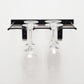 Black wall-mounted stemware rack with two hanging wine glasses