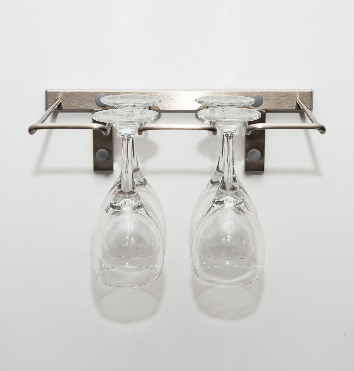 Silver-tone wall-mounted stemware rack holding two wine glasses