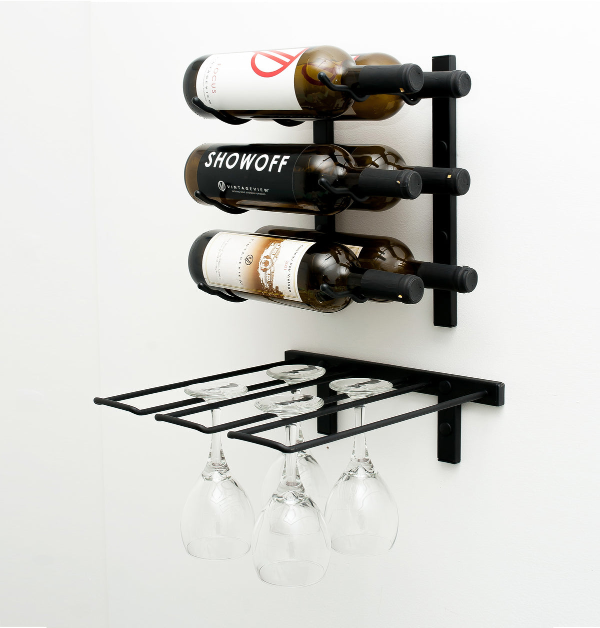 Black wall-mounted wine display rack with hanging glasses under a top frame